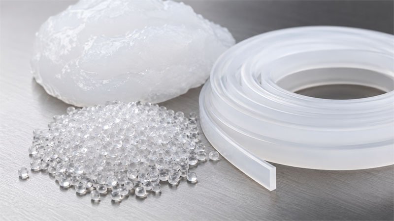 Platinum cured silicone raw material — translucent granules and HCR strip used for FDA and LFGB compliant manufacturing